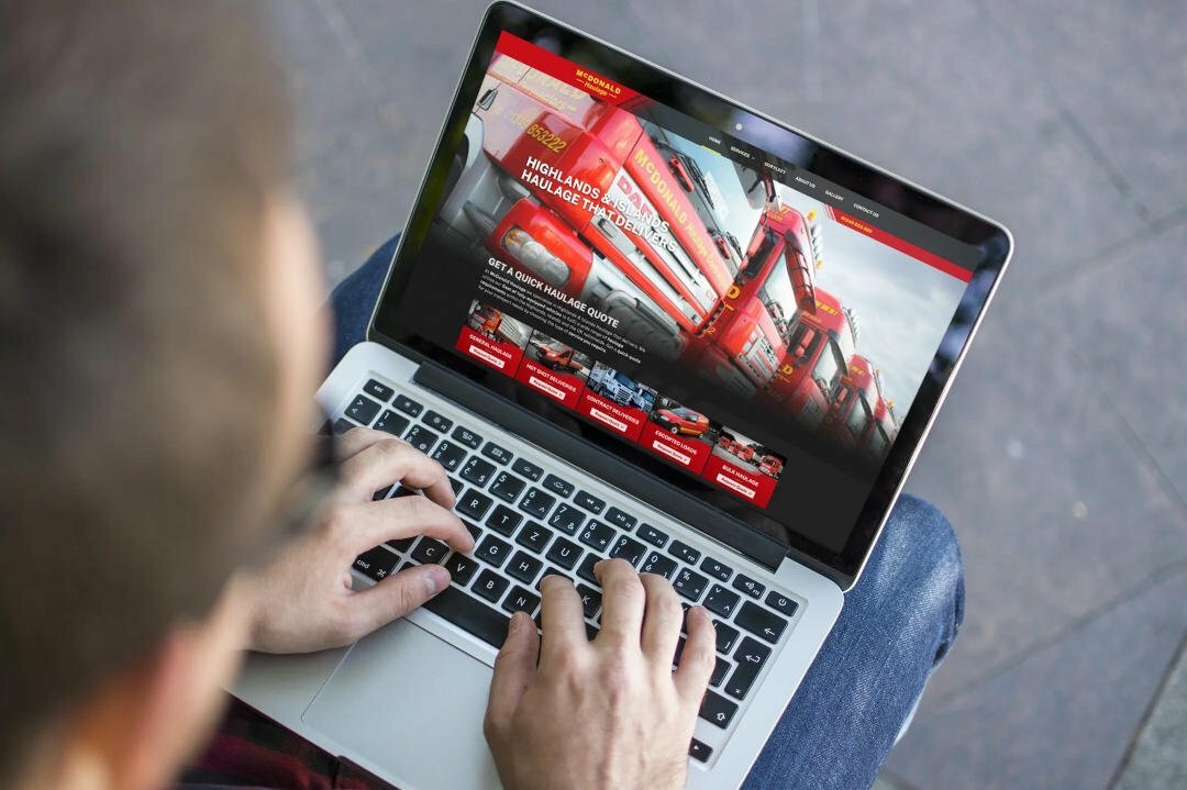 red lorries viewed on laptop